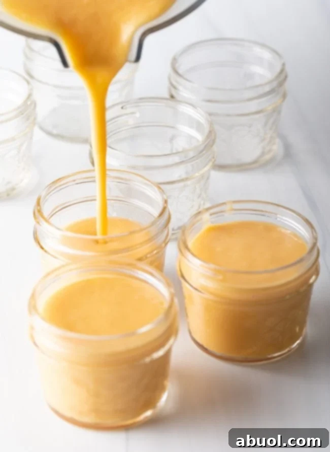 Step 6: Blended mango pudding mixture being poured into individual serving cups.