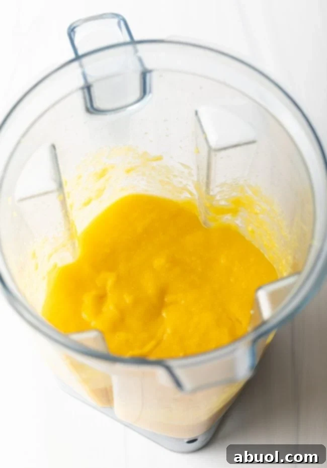Step 3: Blending mango chunks into a smooth puree.