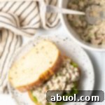 A finished bowl of Tuna Salad with Apples, garnished with fresh dill.