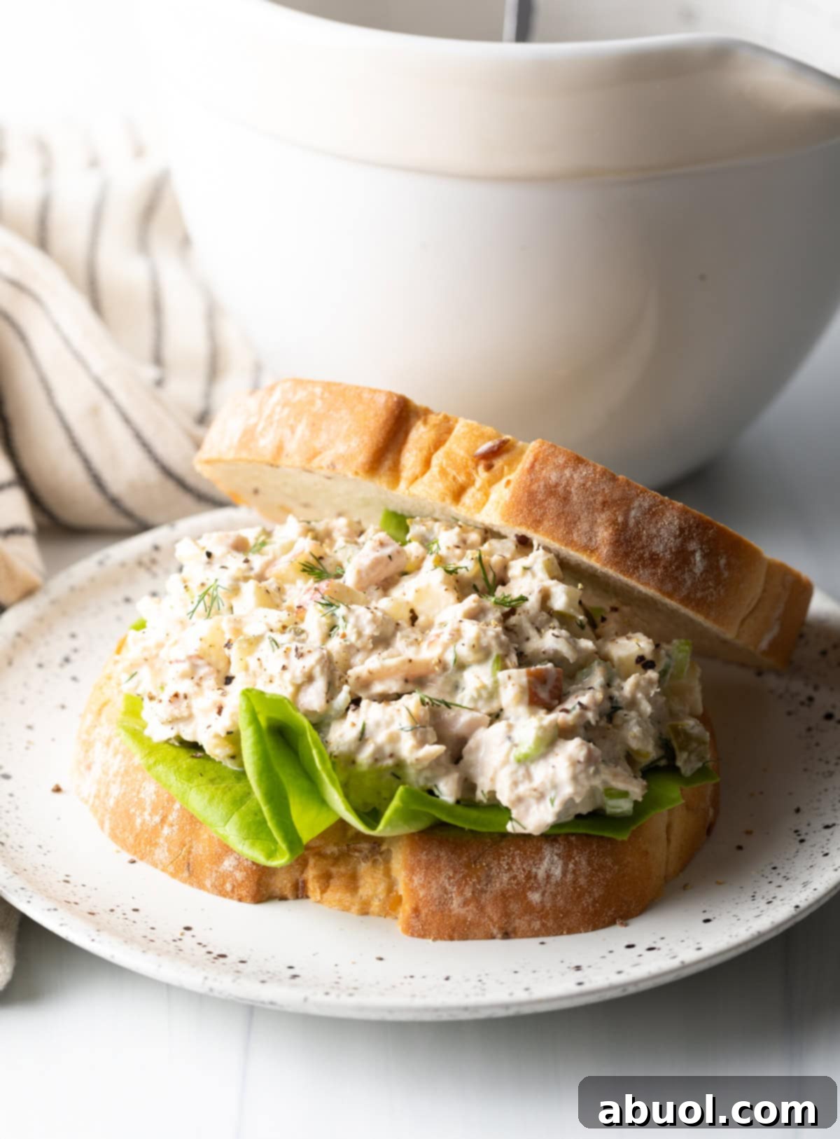 Delicious bread slices layered with fresh lettuce and a generous scoop of homemade tuna salad with apples.