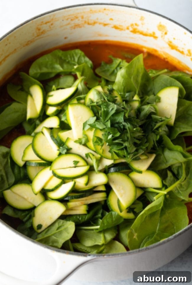 A small bowl of tomato paste, a key ingredient for deepening the soup's flavor.