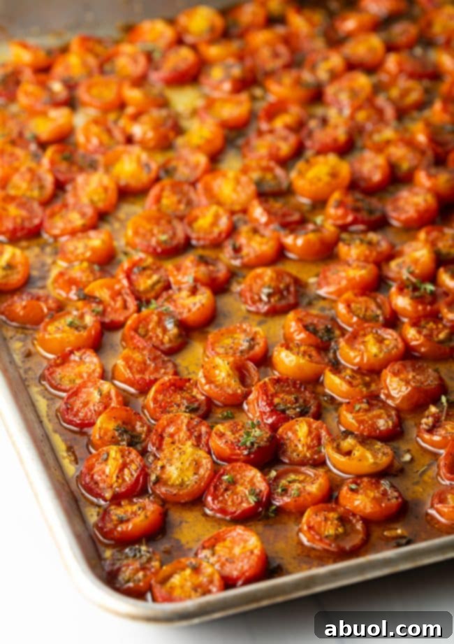 Roasted cherry tomatoes on a baking sheet.