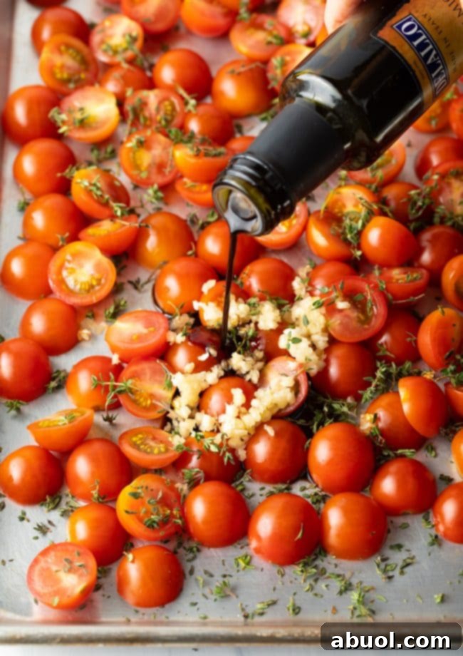 pouring balsamic vinegar over tomatoes