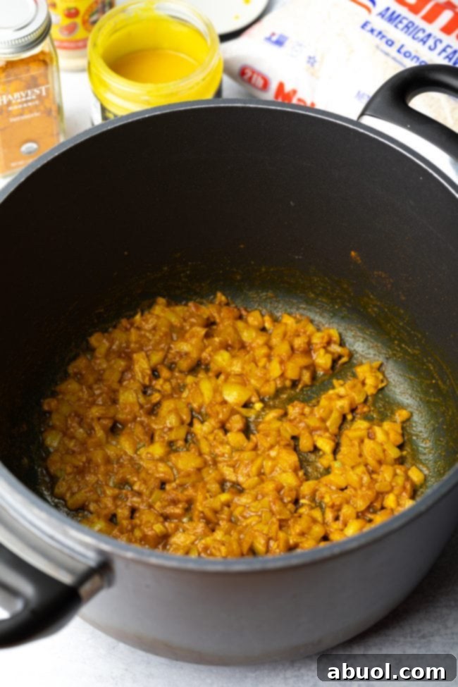 Onions and garlic sauteed in cooking pan. 