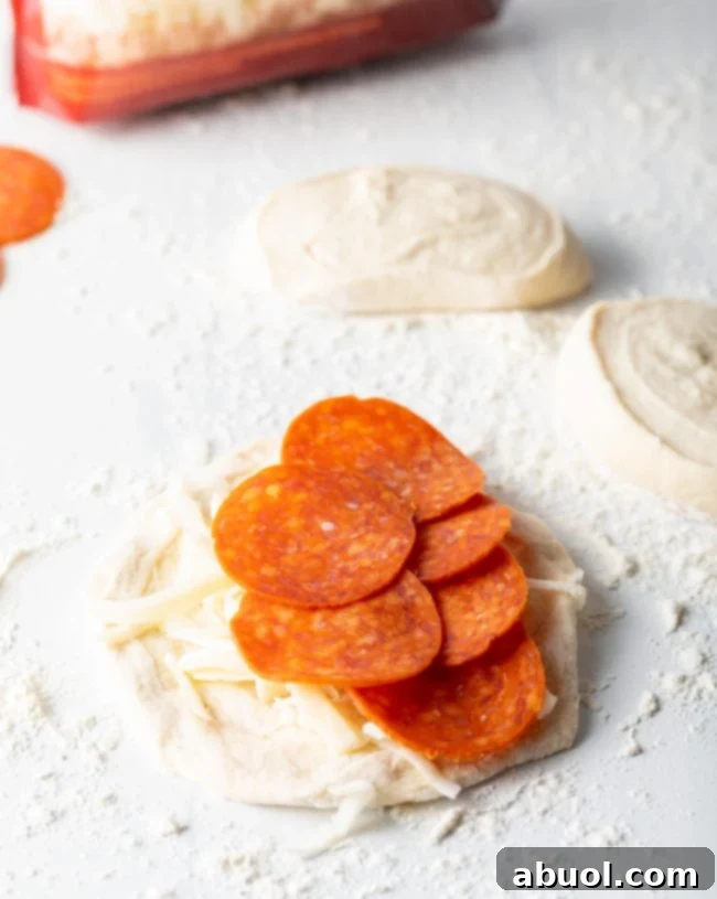 Pepperoni on a piece of pizza dough..
