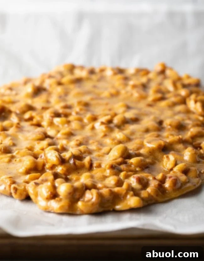 spreading the microwave peanut brittle on parchment