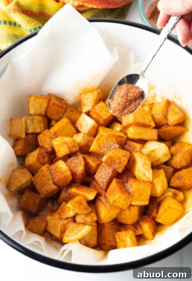 tossing the papas bravas in Mexican spices