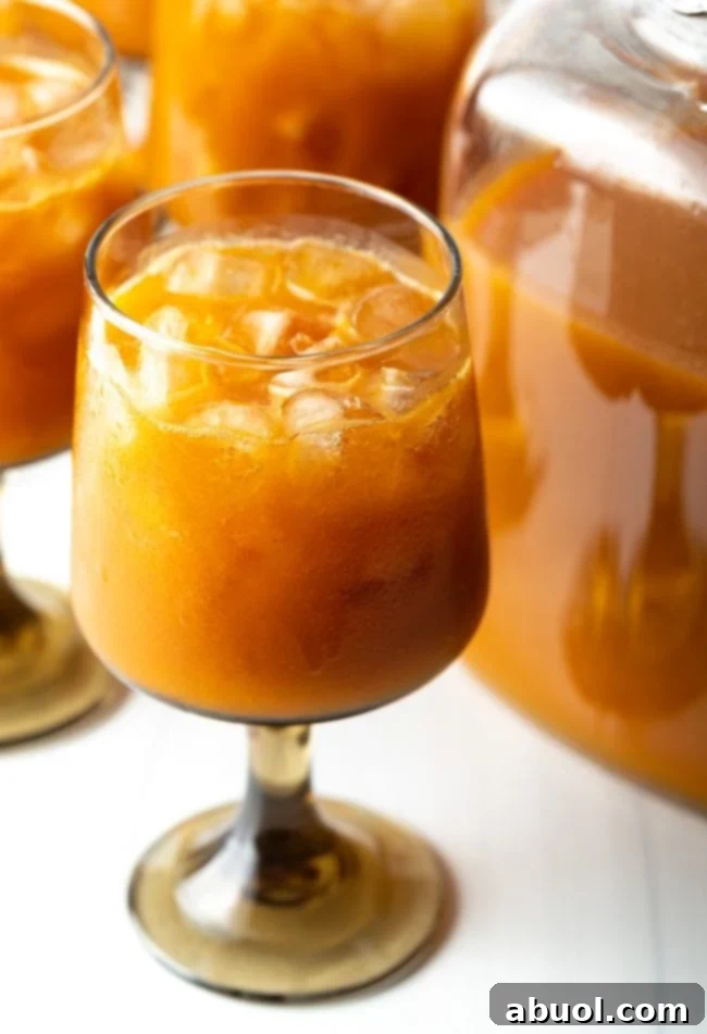 A refreshing glass of chilled Harry Potter Pumpkin Juice with ice, evoking the magic of the Wizarding World.