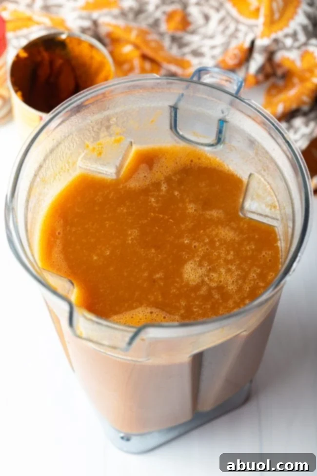All the Harry Potter Pumpkin Juice ingredients, including pumpkin puree, nectar, and spices, blended smoothly together in a high-speed blender, ready for chilling.