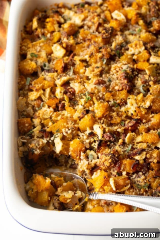 Butternut Squash Casserole -
spoon scooping butternut squash dressing