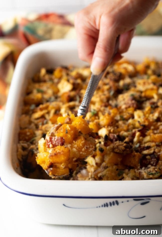 spoon scooping savory butternut squash stuffing