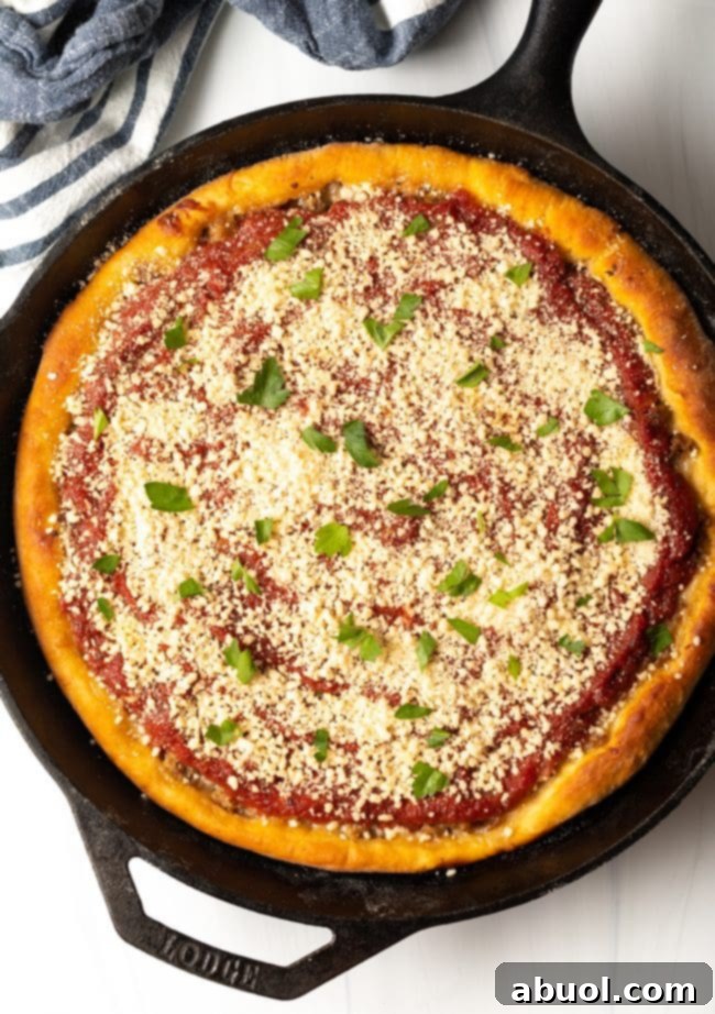 top view baked chicago style pizza with parmesan cheese and parsley