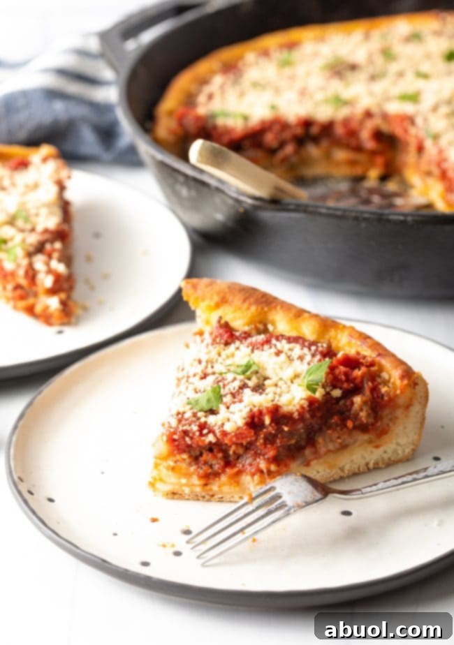 slice of tomato pie with fork on a plate, bite of the pizza taken out