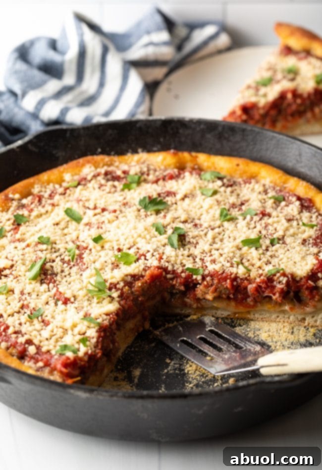 side view cast iron deep dish pizza with slice removed