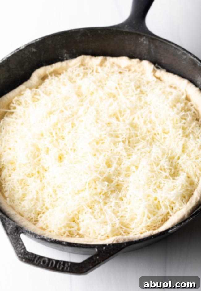 adding cheese to the dough
