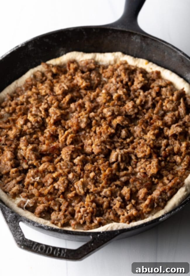 browned sausage on top of the cheese and dough