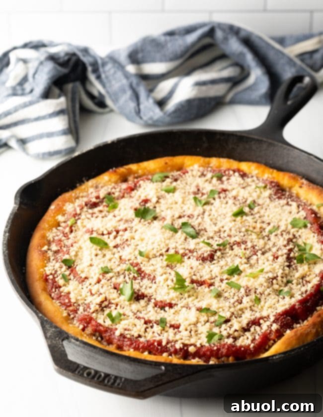 side top view of baked deep dish chicago style pizza in a cast iron skillet