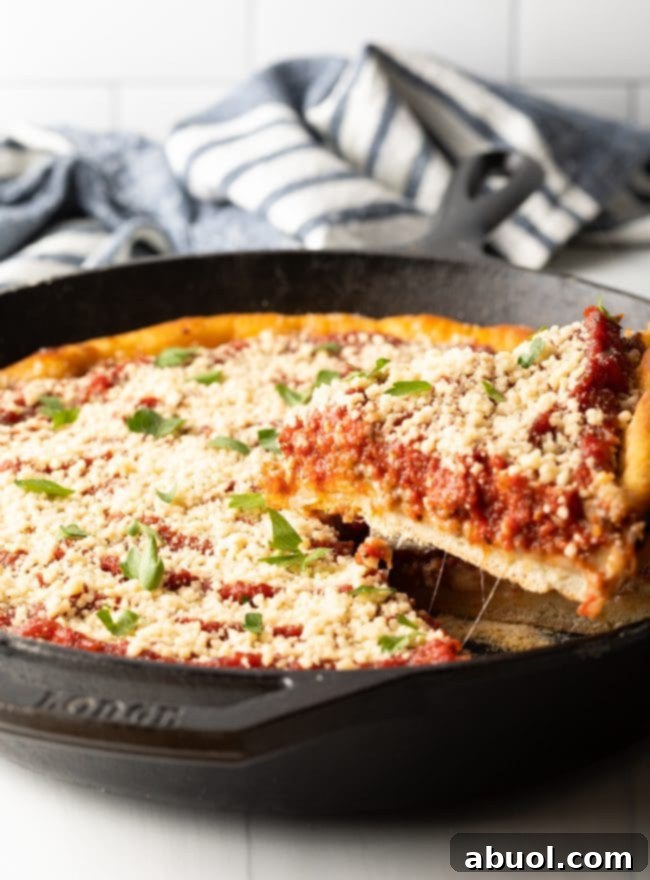 removing a slice of pizza from a cast iron skillet