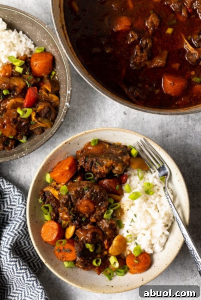 Jamaican oxtail stew recipe in a bowl with white rice.