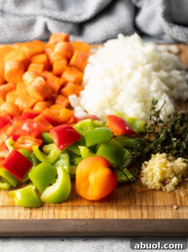 Chopped veggies needed for stew on a cutting board. 