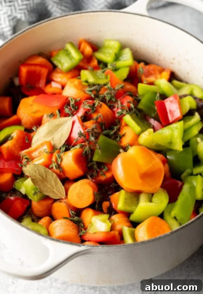 Pot filled with veggies and herbs and slow cooked oxtail. 