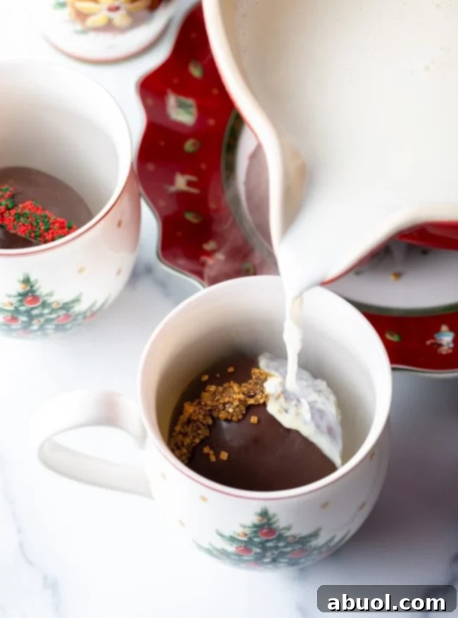 Velvet Cocoa Spheres 5 Hot milk being poured over hot chocolate bomb.