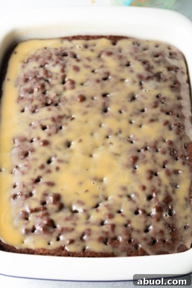 Chocolate cake layered with chopped toffee bars before adding whipped topping