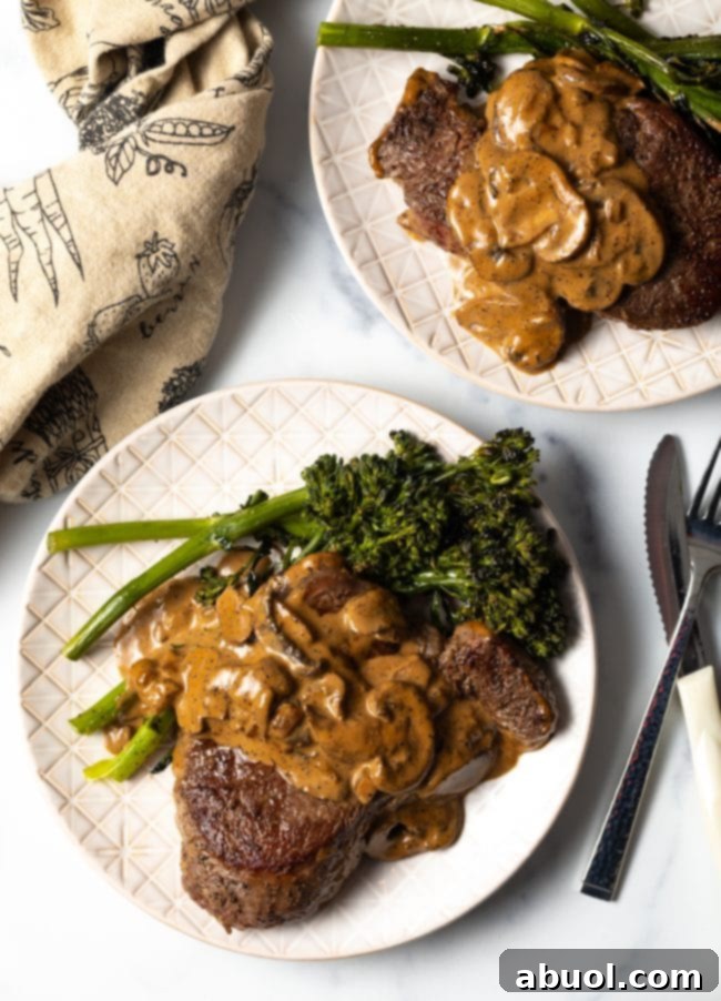 Cheesecake Factory's Iconic Steak Diane 4 Top view beef filet with mushroom cognac sauce and broccolini. A close-up of the delicious Steak Diane.