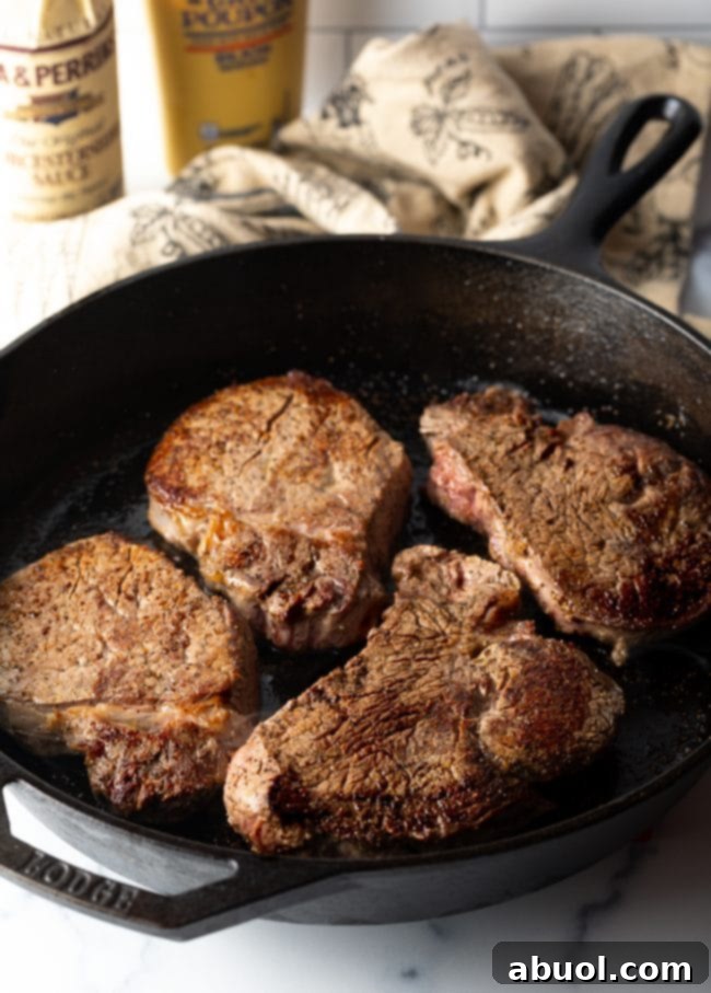 Cheesecake Factory's Iconic Steak Diane 5 4 steaks in a cast iron skillet. Searing steaks for Steak Diane.