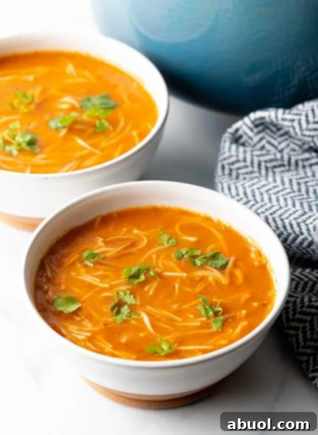 Two bowls of Mexican Sopa de Fideo garnished with fresh cilantro.