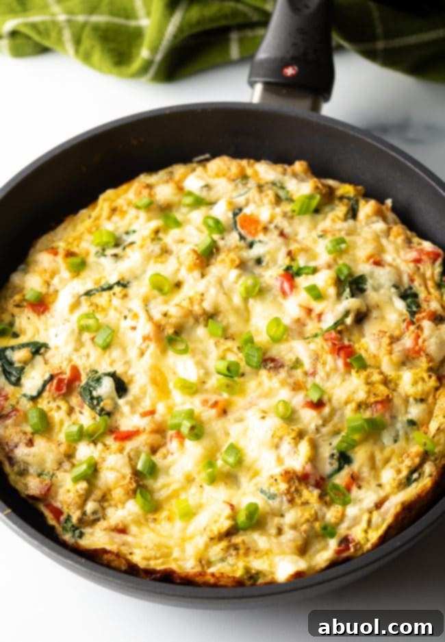 baked egg white and peppers frittata in a cast iron skillet, showcasing a golden and perfectly set meal.