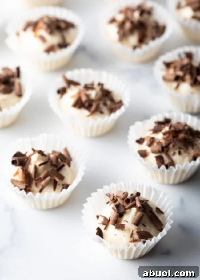 Many no-bake fat bombs with chocolate shavings in little paper muffin liners.