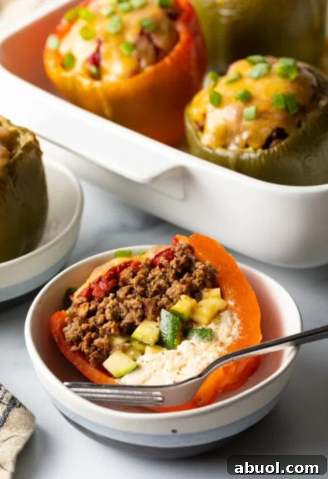 Mediterranean stuffed bell pepper without rice cut in half in a bowl with fork.