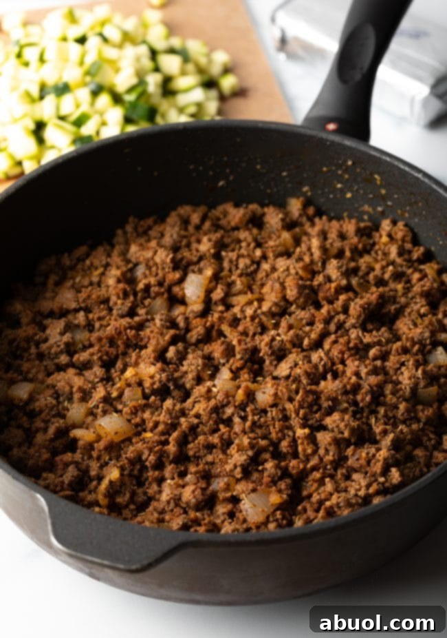 Skillet of browned crumbled ground beef.