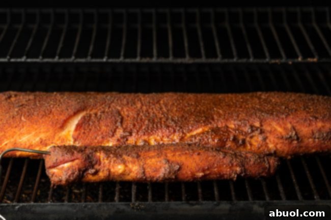 Ultimate Smoked Pork Loin Rub 7 loin and tenderloin in a smoker with Smoked Pork Loin Rub, illustrating placement on grates