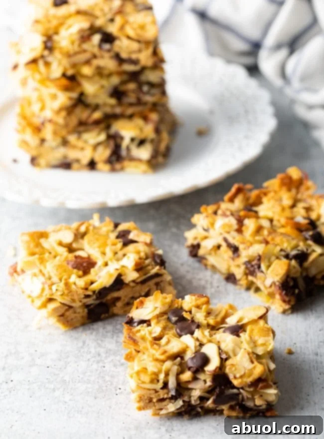 Low Carb Keto Cereal Snack Bars 11 Several squares of keto cereal treats with coconut and nuts arranged on a gray background, ready for snacking.