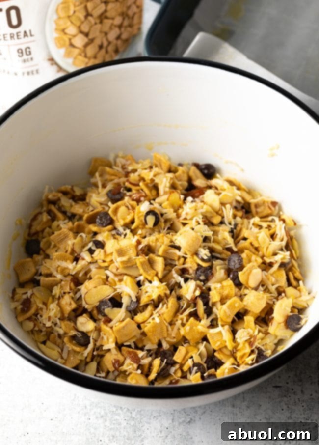 Low Carb Keto Cereal Snack Bars 6 White bowl with keto cereal mix coated evenly in egg, ready for baking.