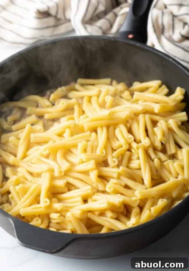 Boiled and drained Gemelli pasta in a skillet, ready for the sauce.
