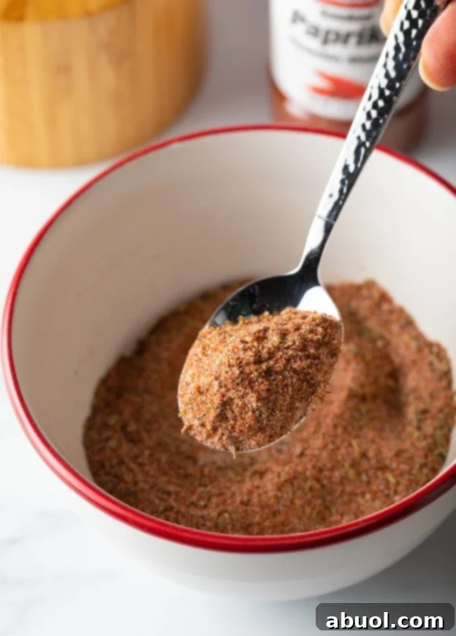 Spoon holding bit of spice blend towards camera.