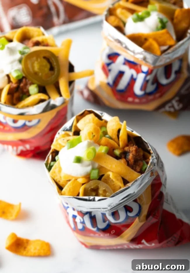 Three bags of fritos filled with frito chili pie.