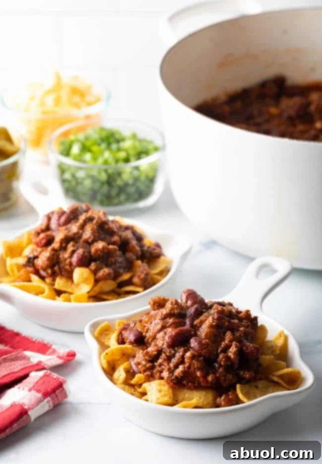 Corn chips in a shallow bowl topped with chili.