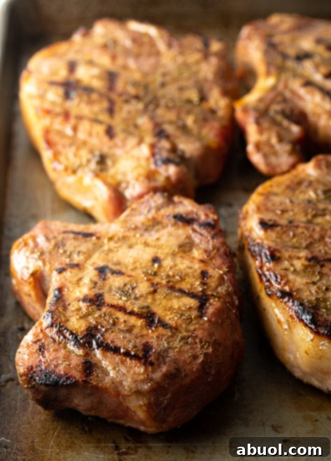 Perfectly Smoked Pork Chops on a Traeger grill, showcasing their golden-brown crust and juicy interior.