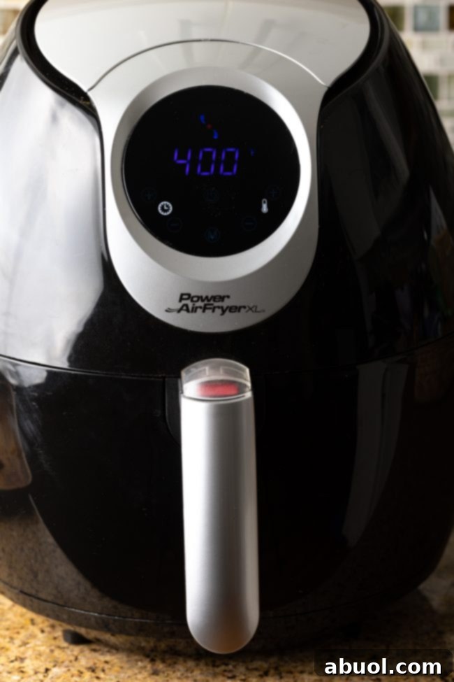 A digital air fryer display set to 400 degrees Fahrenheit, indicating preheating.