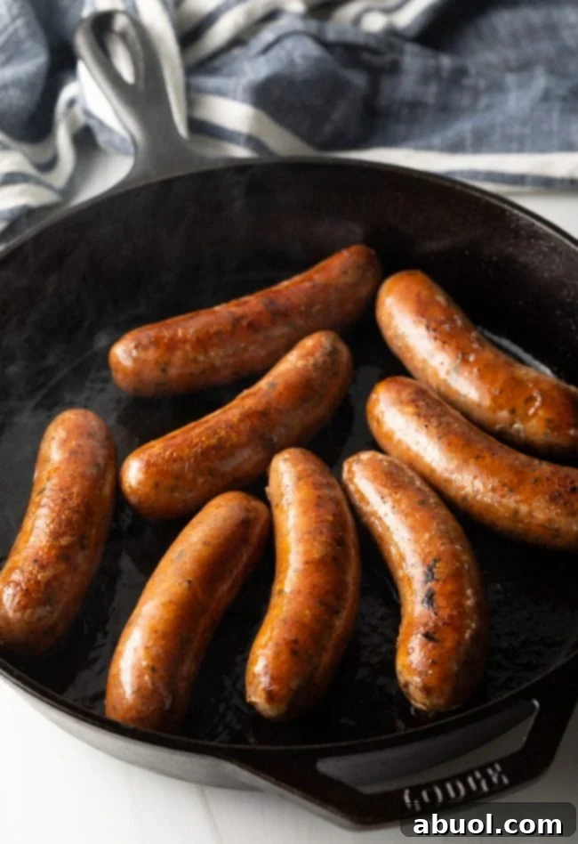 Sausages being grilled on sauteed. 