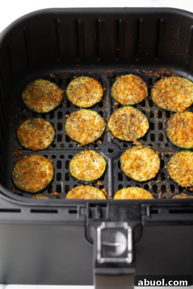 Crispy Air Fryer Zucchini Crisps 9 Slices of zucchini fried in the air fryer topped with parmesan cheese.