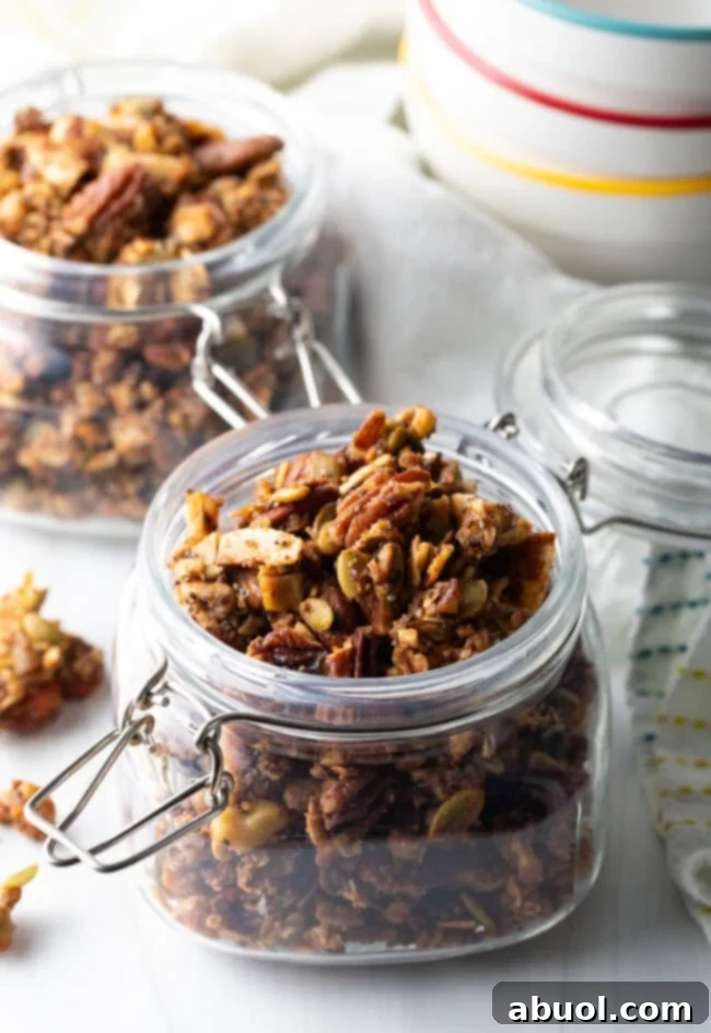 Ultimate Keto Granola Crunch 2 Open glass jar brimming with homemade keto nut granola.