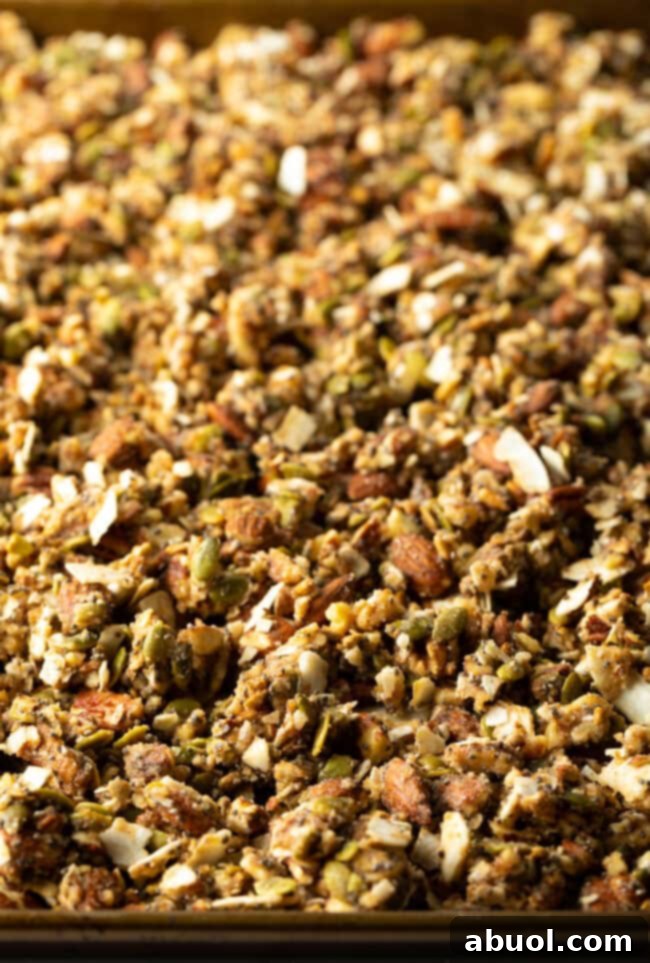 Ultimate Keto Granola Crunch 11 Baked granola on a baking sheet, golden brown and clumpy.