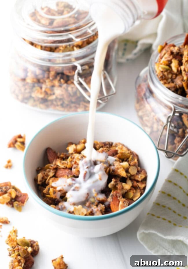 Ultimate Keto Granola Crunch 15 Pouring milk from a jug into bowl of keto nut granola.