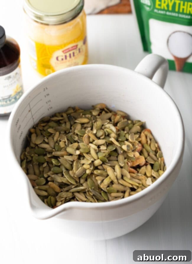 Ultimate Keto Granola Crunch 7 Close up of coconut flakes added to nuts and seeds.