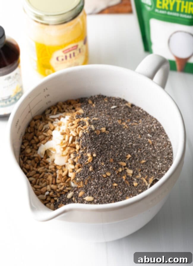 Ultimate Keto Granola Crunch 8 Mixing ghee and almond butter in a small bowl.